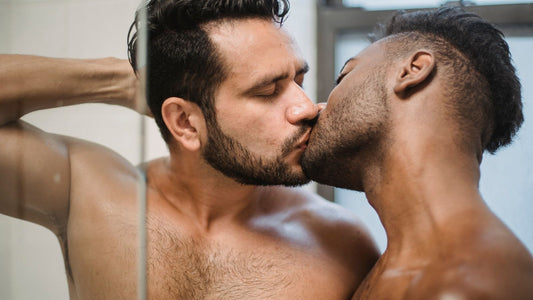 Two men sharing a passionate kiss — male pleasure and sexual wellness