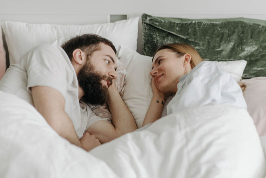 Couple talking face to face in bed, warm and intimate conversation