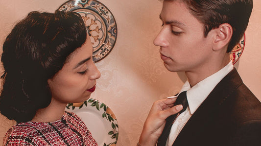 Woman confidently holding her partner by his tie — playful, consensual female-led power dynamic
